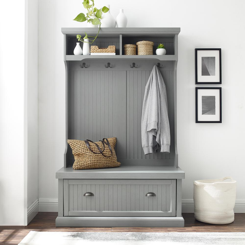 Front view of a hallway and entryway storage rack in gray color showing storage cubicles and coat rack 