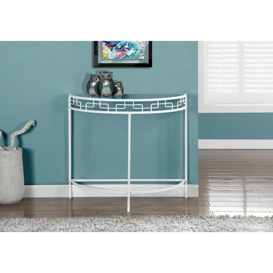 Living room view of an accent table for hallways or entryways in a shape of a half moon. The table top is clear glass and is supported by a white metal frame