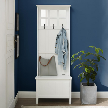 Front view of a white entryway hall storage with a storage bench and coat rack