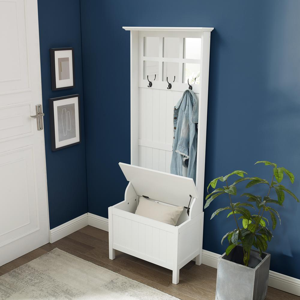 View of a white entryway hall storage with a storage bench and coat rack