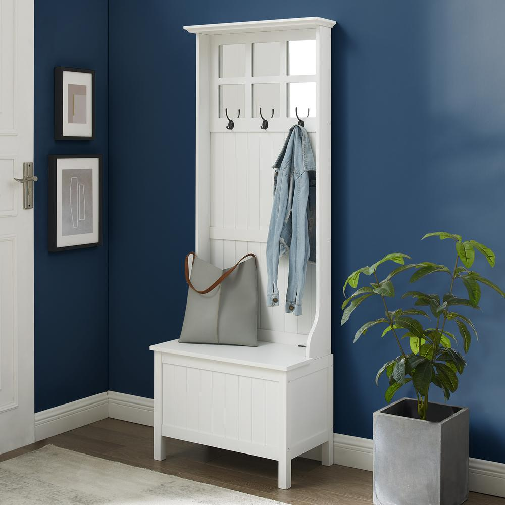 Side view of a white entryway hall storage with a storage bench and coat rack