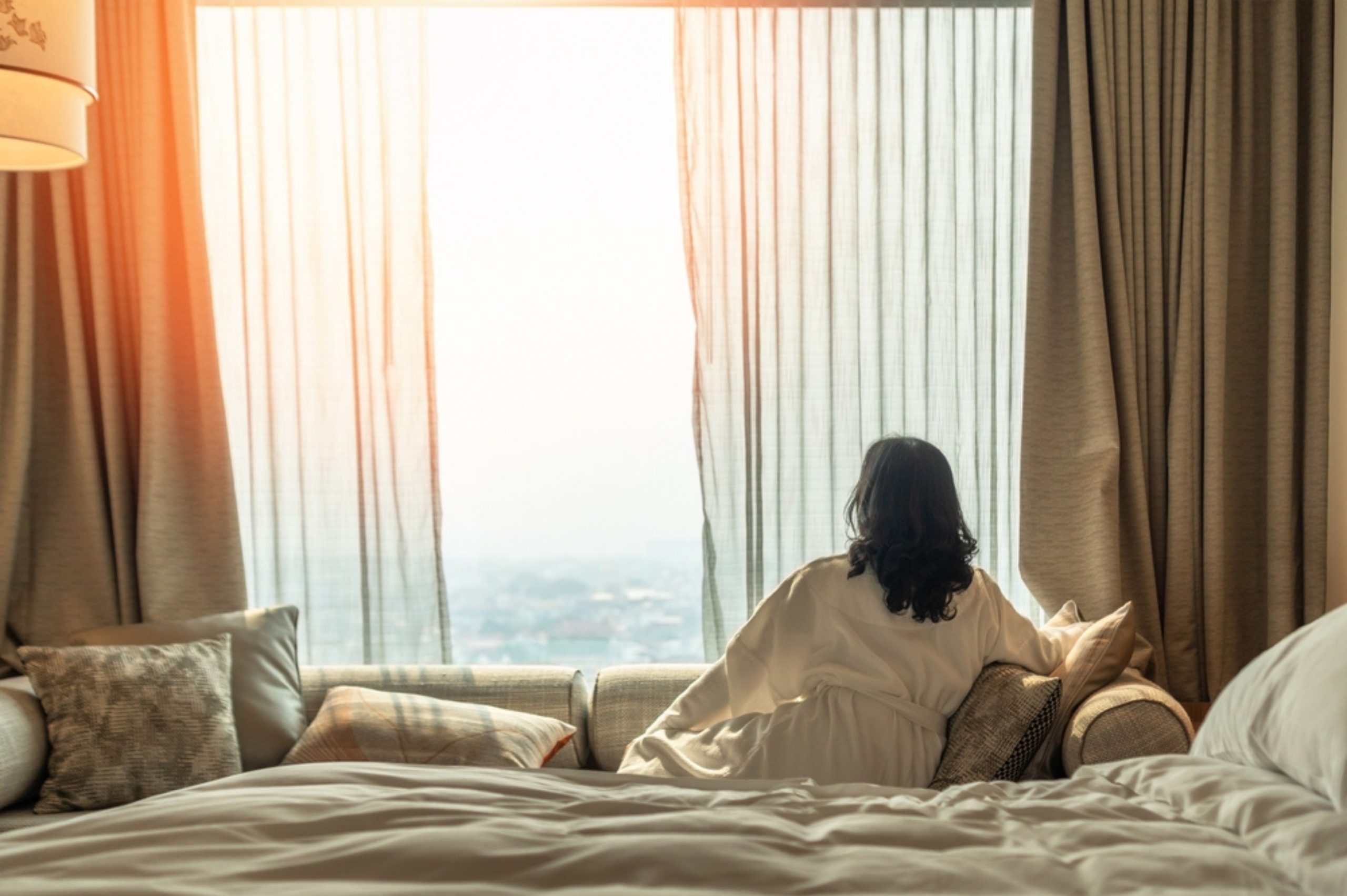 woman looking out the window in the morning